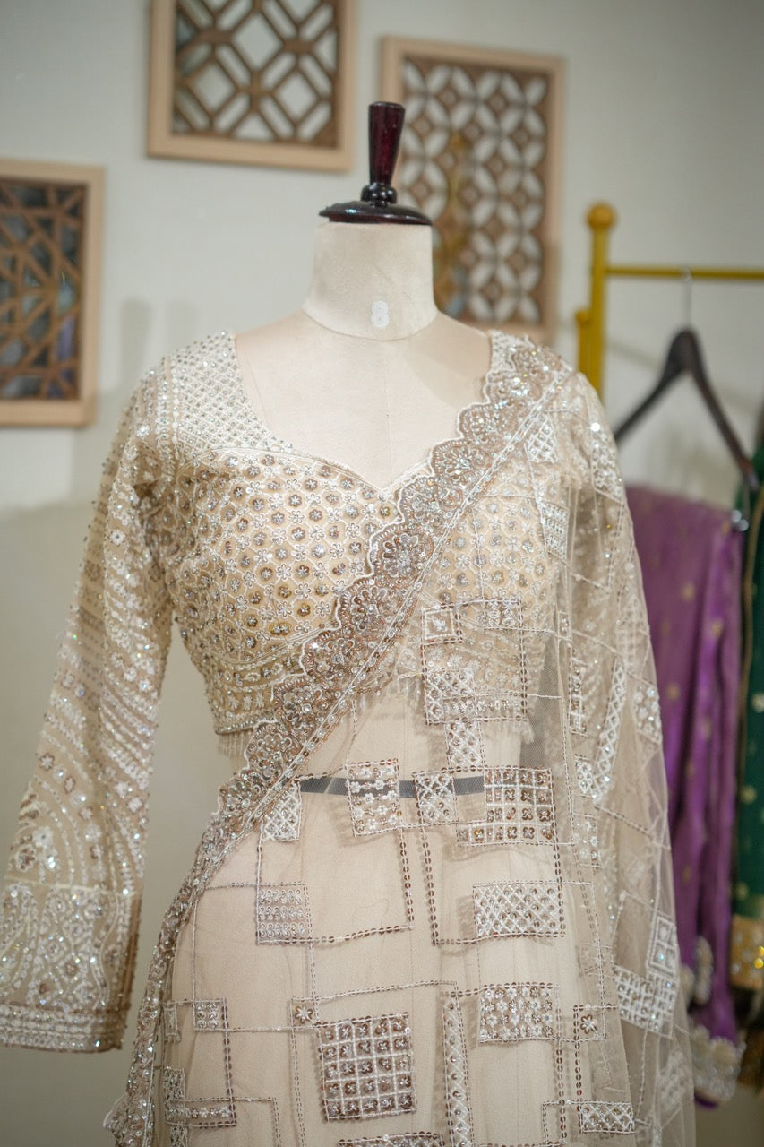 Tusker: Ivory Softnet Saree with Handwork paired with self handwork blouse.