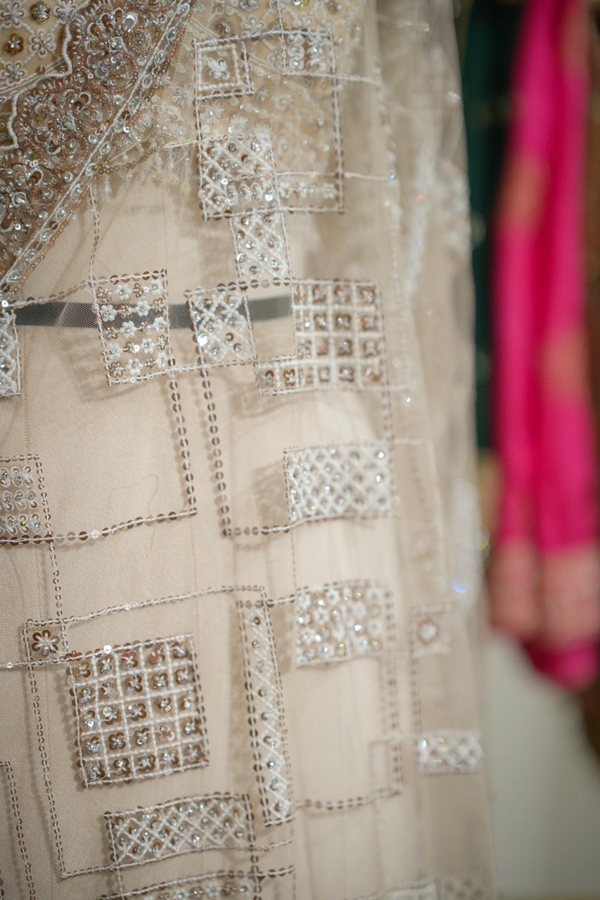 Tusker: Ivory Softnet Saree with Handwork paired with self handwork blouse.
