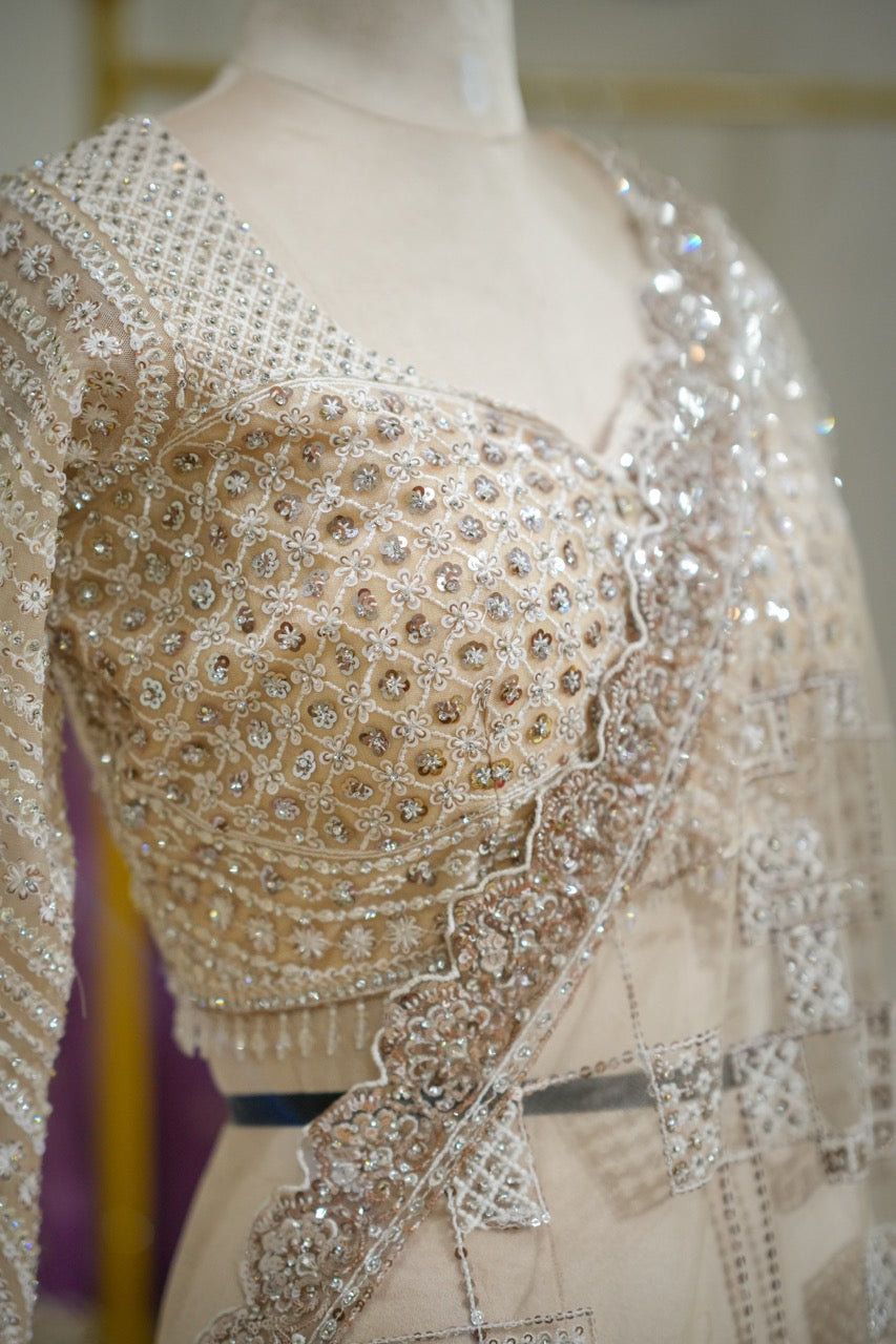 Tusker: Ivory Softnet Saree with Handwork paired with self handwork blouse.