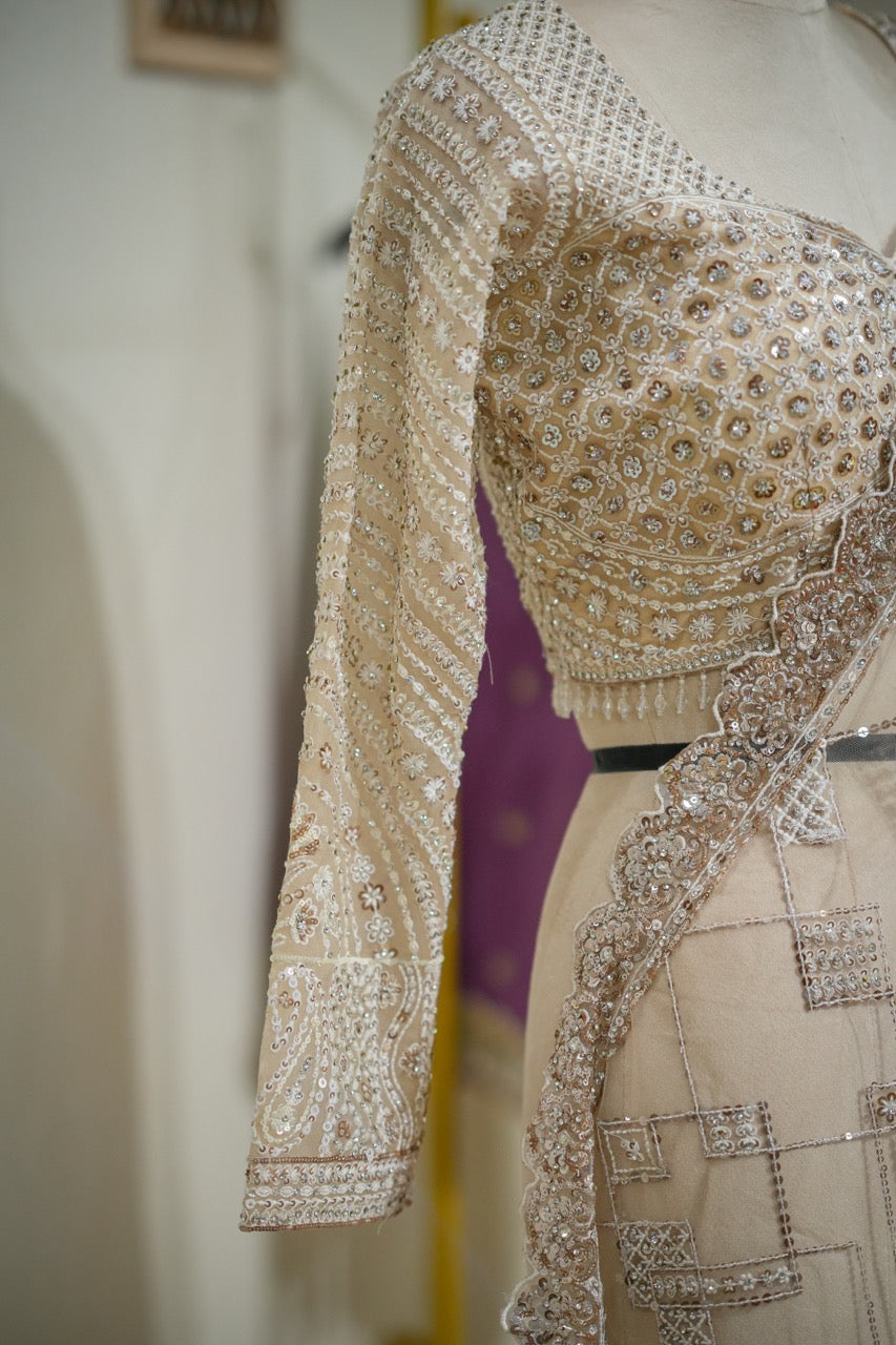 Tusker: Ivory Softnet Saree with Handwork paired with self handwork blouse.