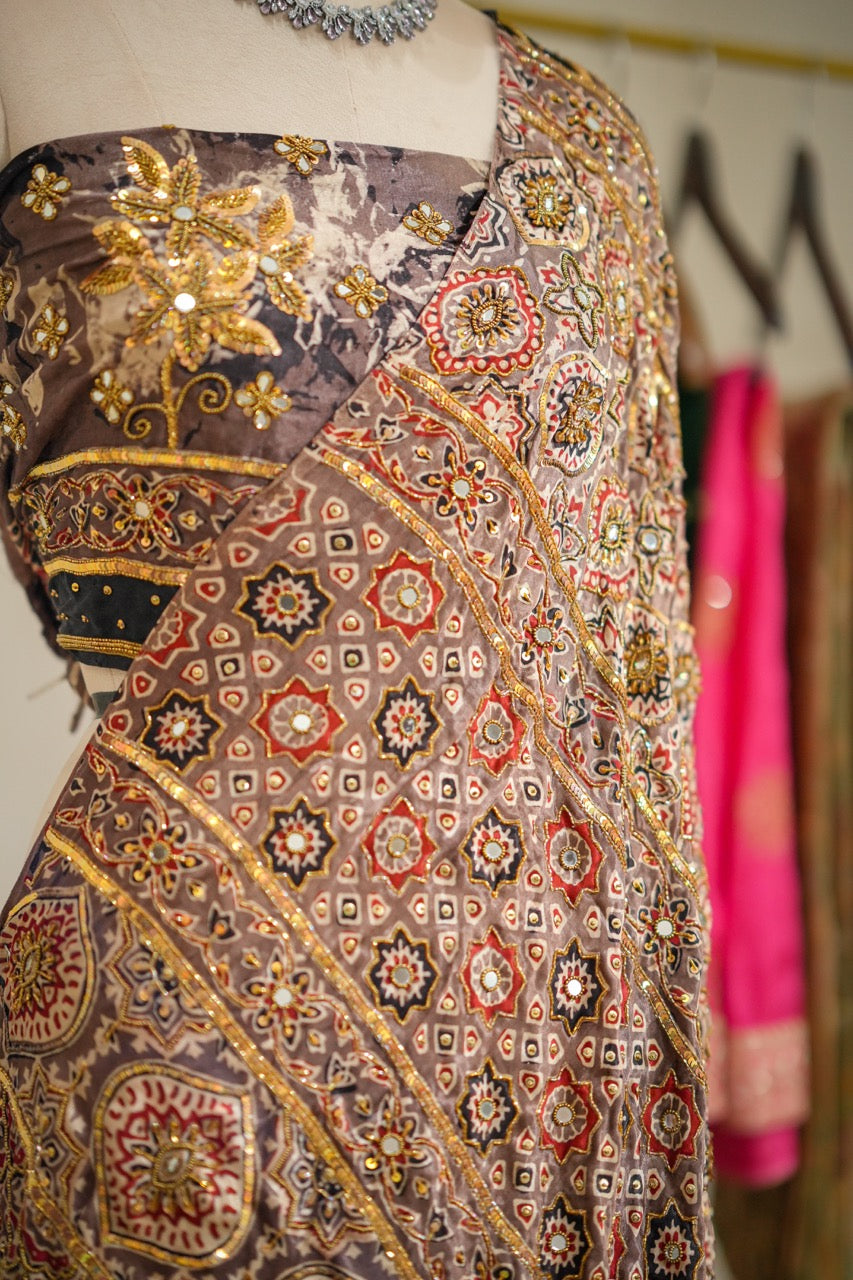 SAEBA: Brown Authentic Handblock Print Ajrakh Saree on Modal Satin with handwork on Saree and Blouse
